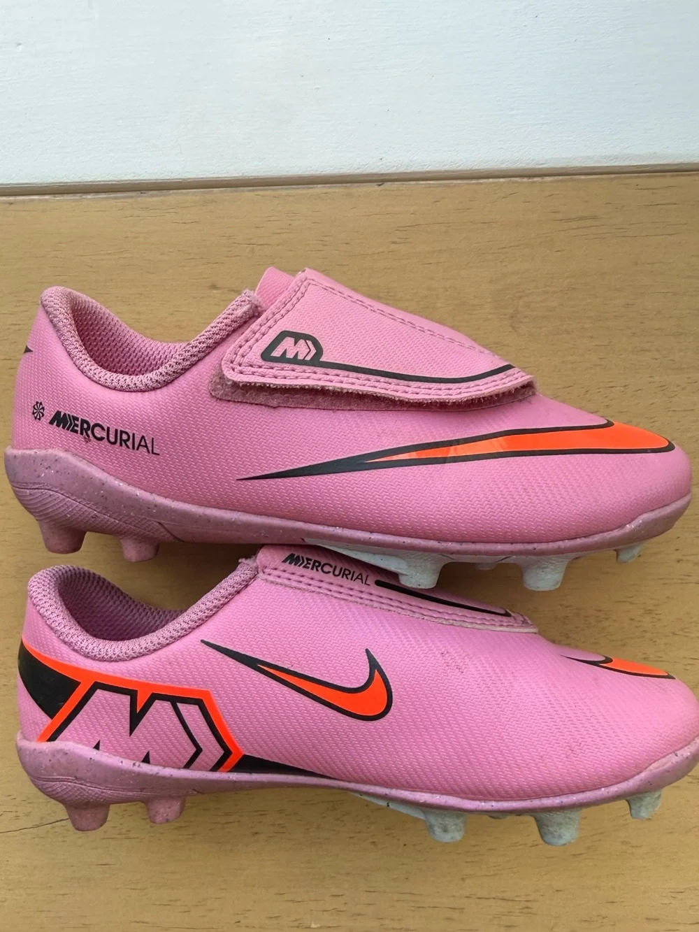 Nike Mercurial Kids Pink Soccer Cleats with Orange and Black Accents
